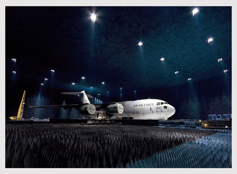 Military aircraft in dark hangar