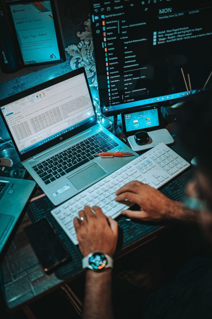 Person working on multiple screens